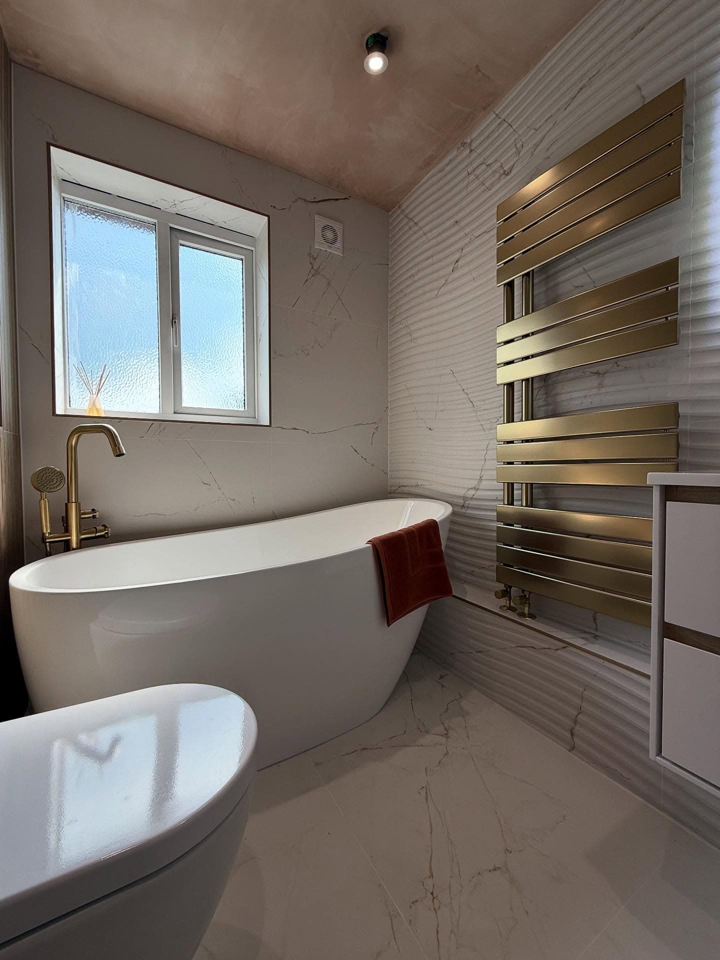 Finished bathroom detail with premium tiling, fitted sanitaryware and clean installation lines