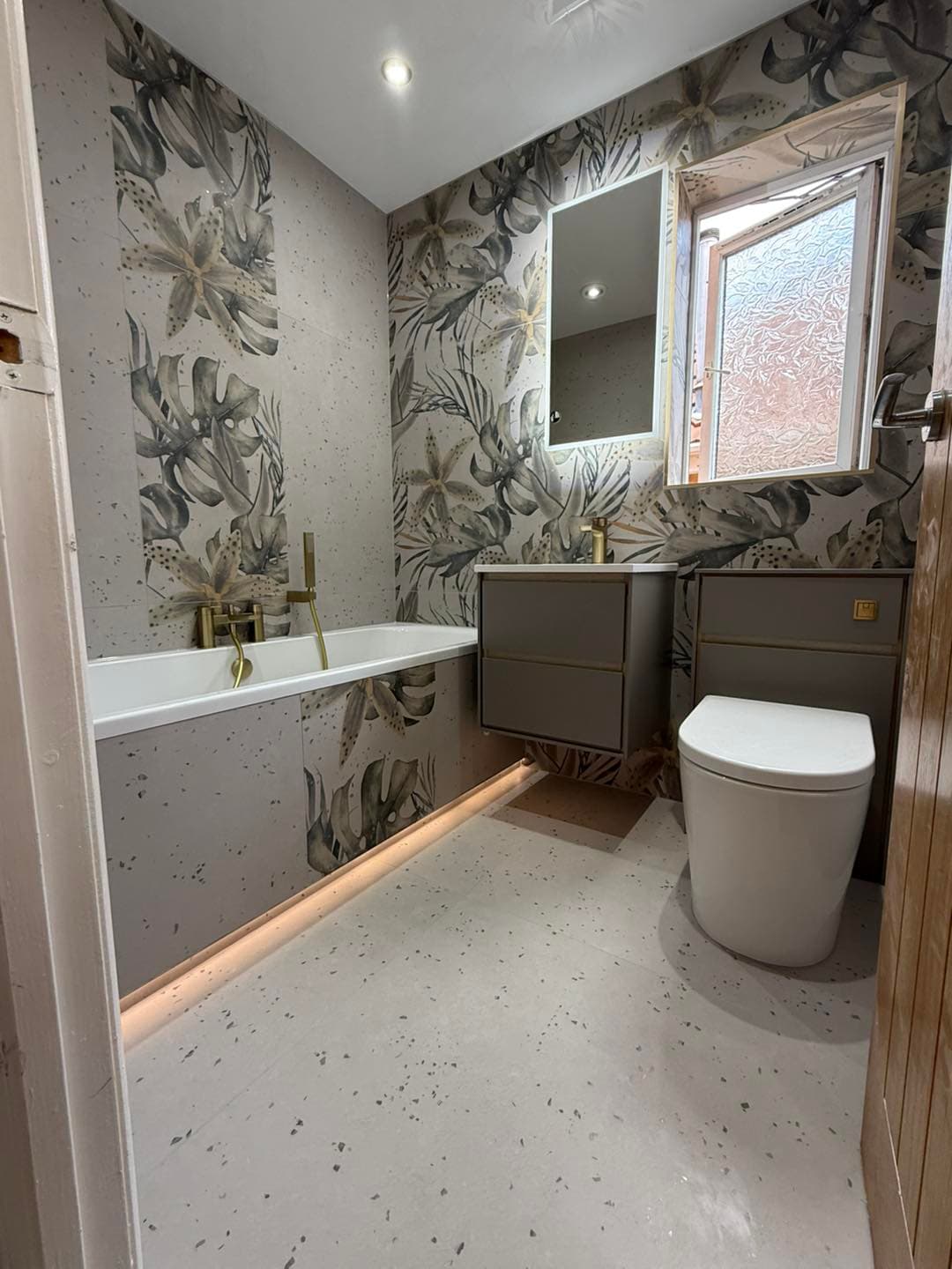 Modern bathroom installation with clean tiling and coordinated fittings