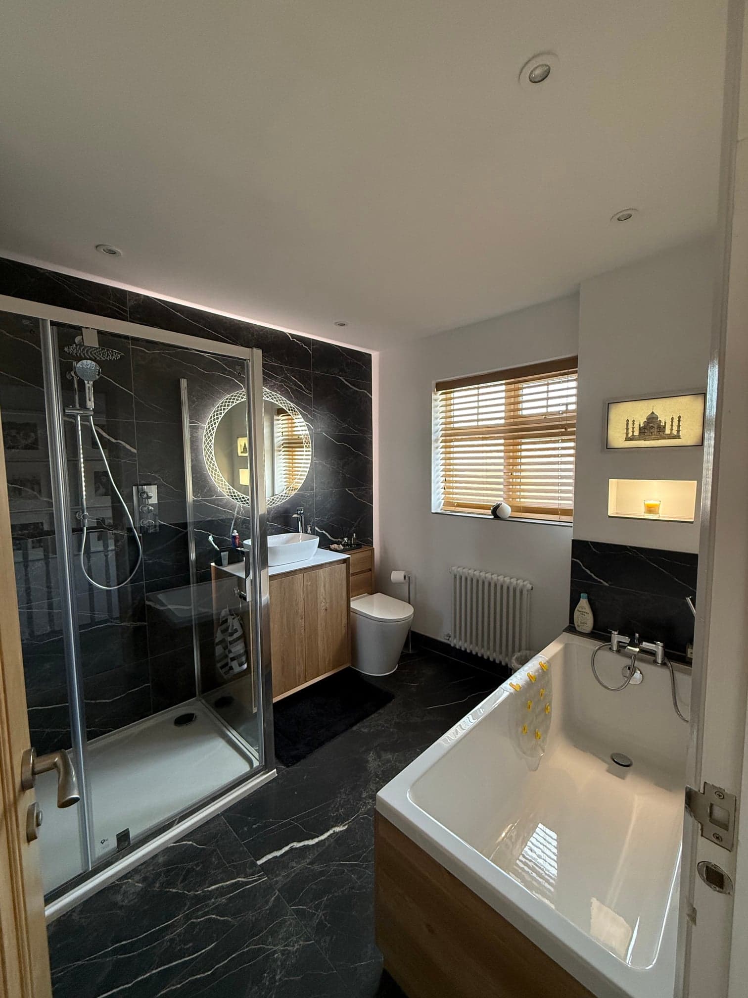 Bathroom renovation detail showing suite and wall finish